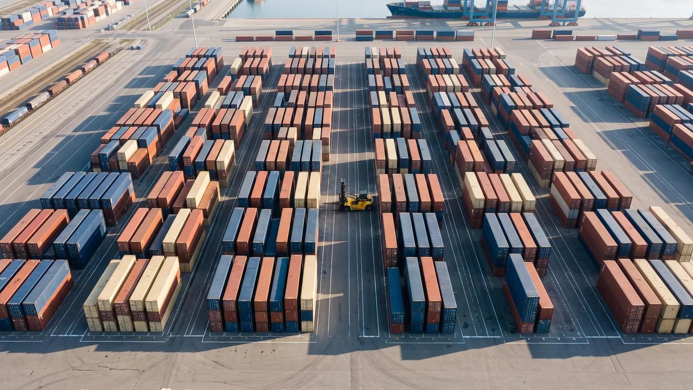Container yard seen from above, rows forming a clean grid.