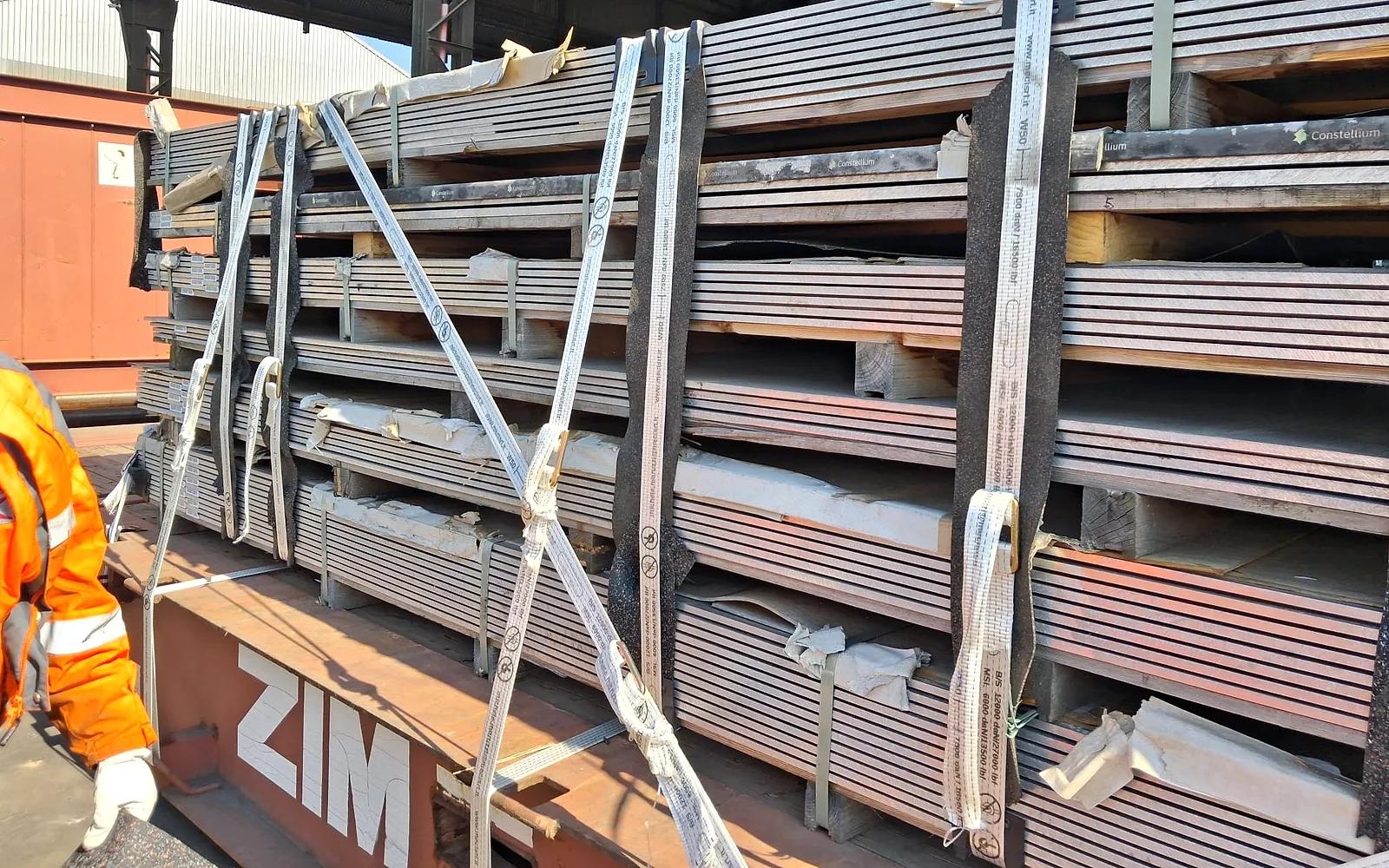 Containers and trailers at the dock of a Delta Novel warehouse in an Italian port — inbound and outbound execution.